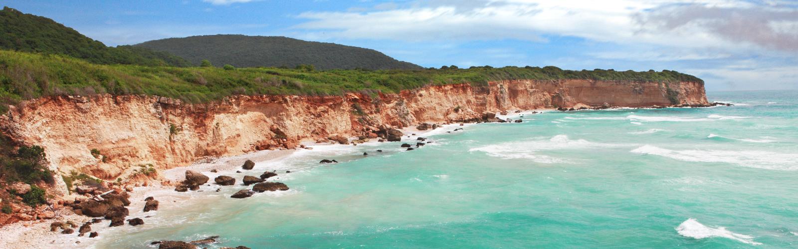 sky outdoor beach mountain water nature ocean landscape coastal and oceanic landforms cliff cloud lake coast bight body of water sandy island land
