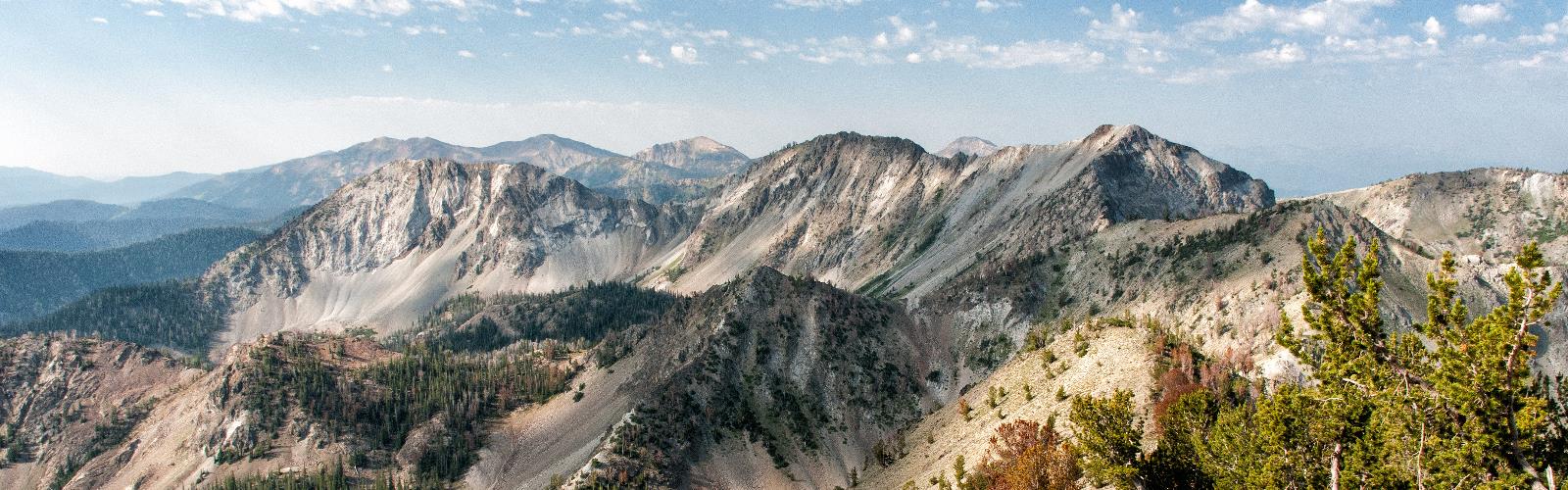 mountain sky outdoor nature valley canyon cloud landscape massif background ridge depression mountain range fell highland dirt hillside land