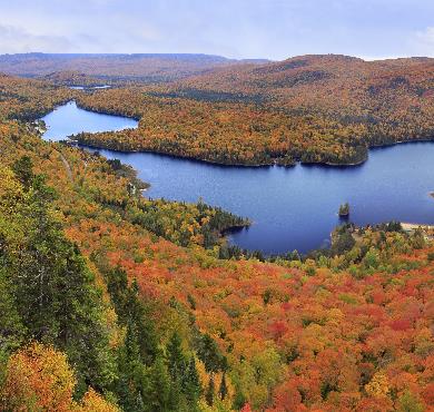 Quebec  water sky outdoor mountain tree river lake autumn grass fall nature landscape hillside overlooking plant surrounded cloud hill beautiful pond traveling lush island land wooded distance