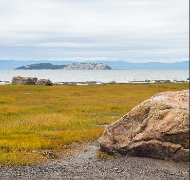 Bas-Saint-Laurent  grass sky outdoor beach mountain lake water nature cloud landscape field rock grassy promontory overlooking lush distance